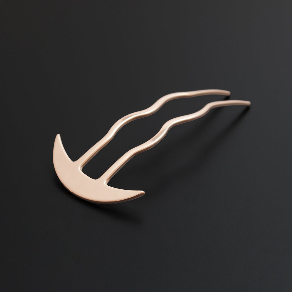 Gold hairpin on a black background