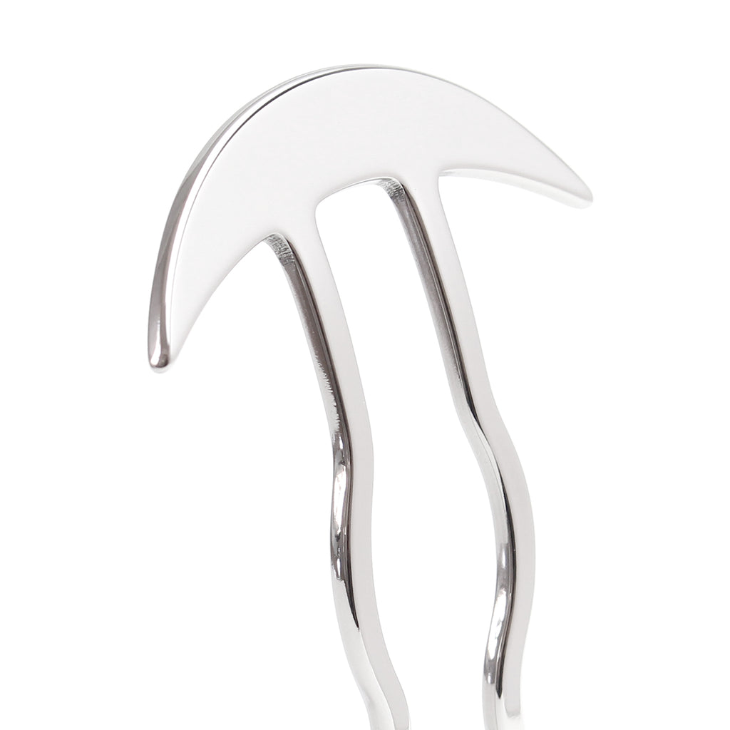close up of a Silver kanzashi with a wave design and a cresent shape atop on a white background