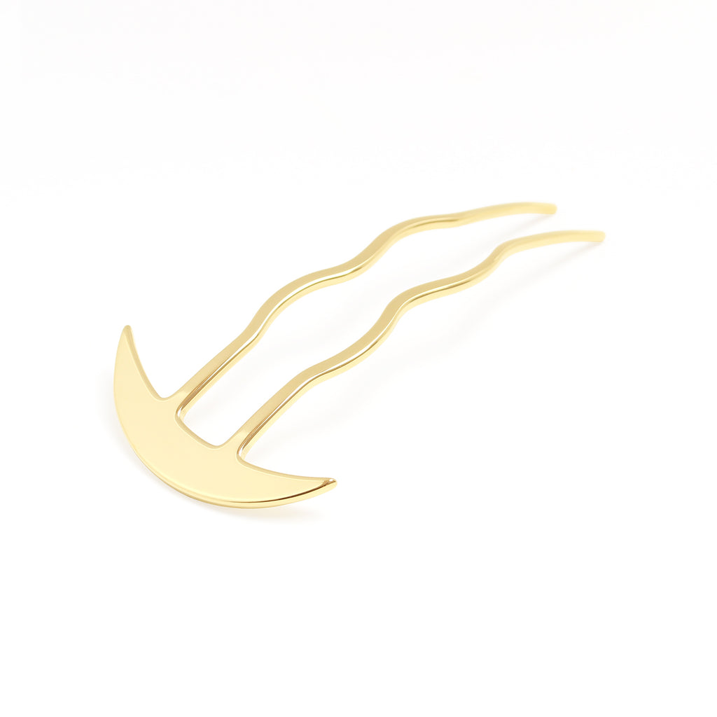 Gold hair clip on a white background