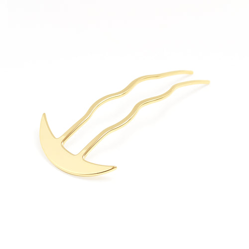Gold hair clip on a white background